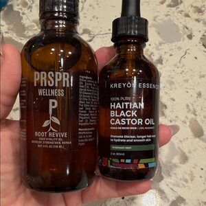 PRSPR Wellness and Kreyo Haitian Castor Oil hair growth moisturizing bottles.